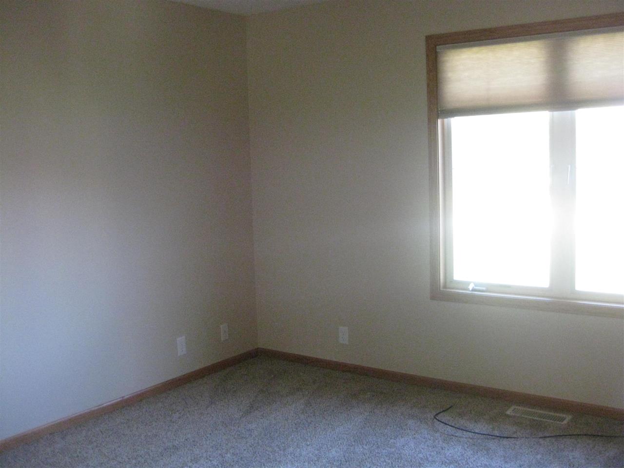 7017 Rye Ridge Trail Cherry Valley, IL 61016 - Photo 18 of 20 an empty room with a window