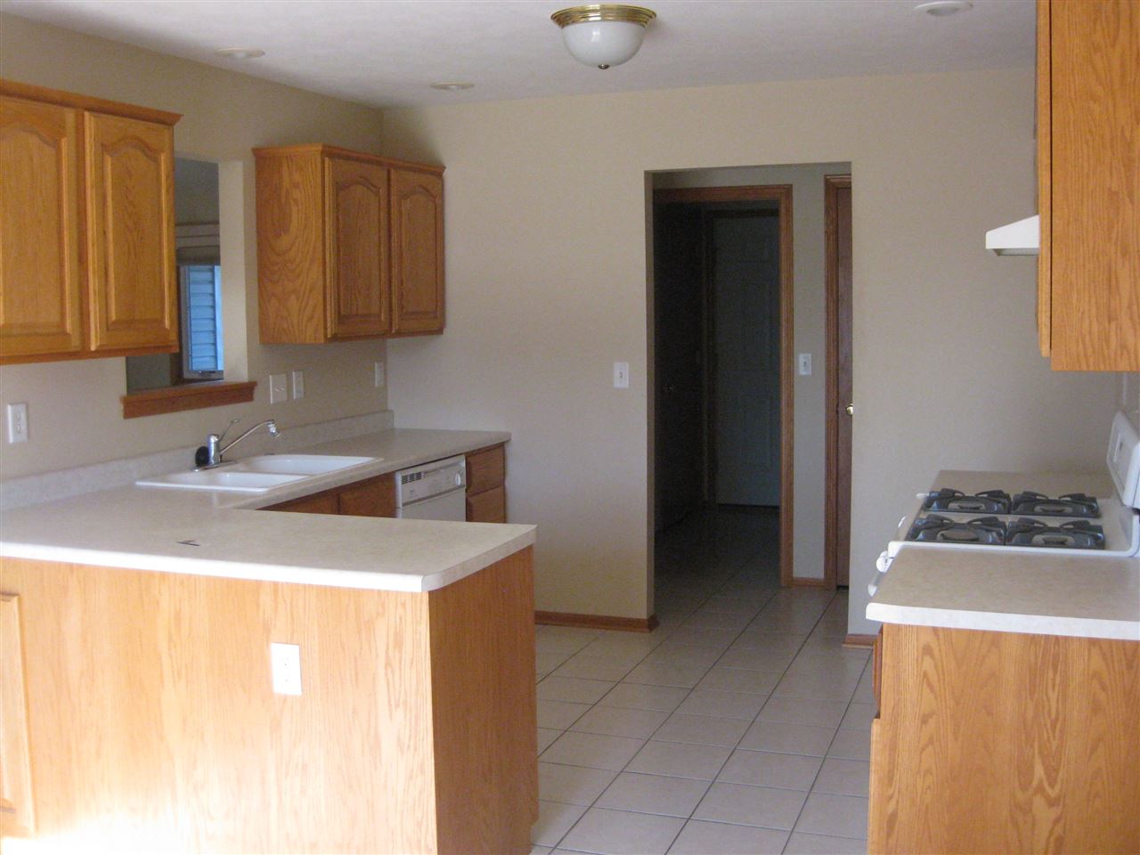 7017 Rye Ridge Trail Cherry Valley, IL 61016 - Photo 4 of 20 a kitchen with a sink a stove and a refrigerator