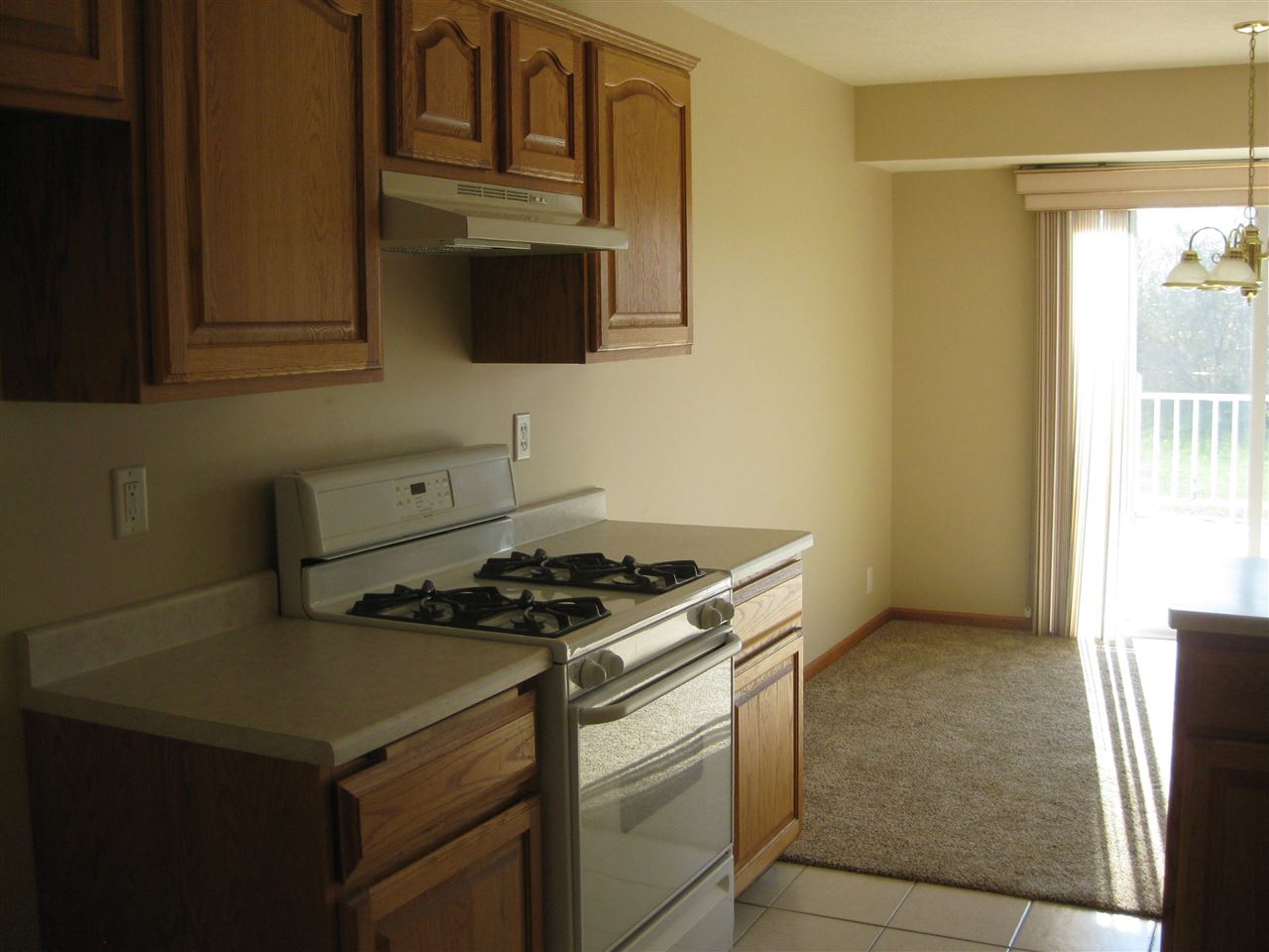 7017 Rye Ridge Trail Cherry Valley, IL 61016 - Photo 6 of 20 a kitchen with stainless steel appliances granite countertop a stove and a microwave