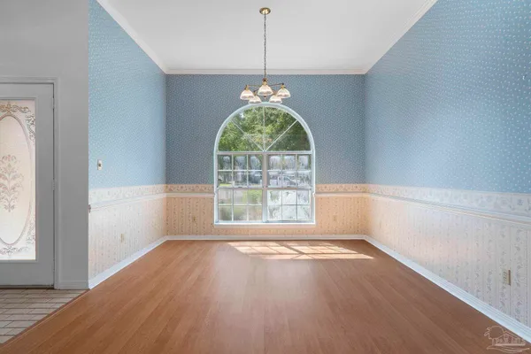a view of a livingroom with a furniture wooden floor and a chandelier