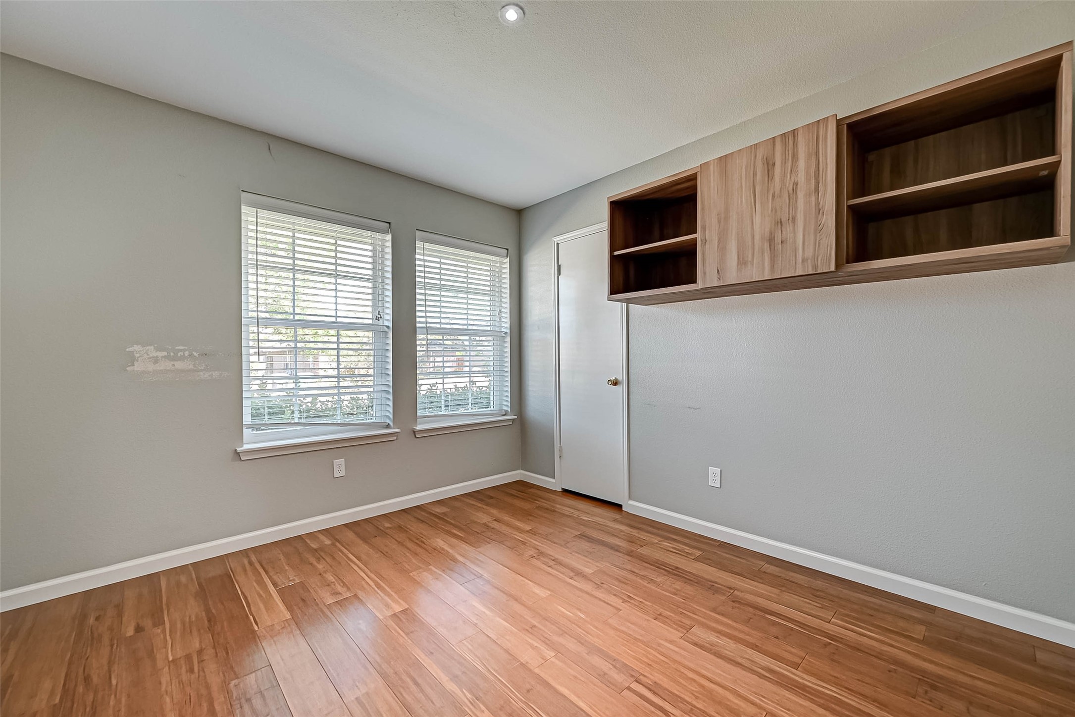 9466 Coast Bridge Street Houston, TX 77075 - Photo 16 of 29 an empty room with wooden floor and windows