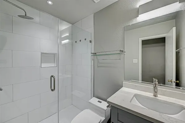 a bathroom with a sink toilet and shower