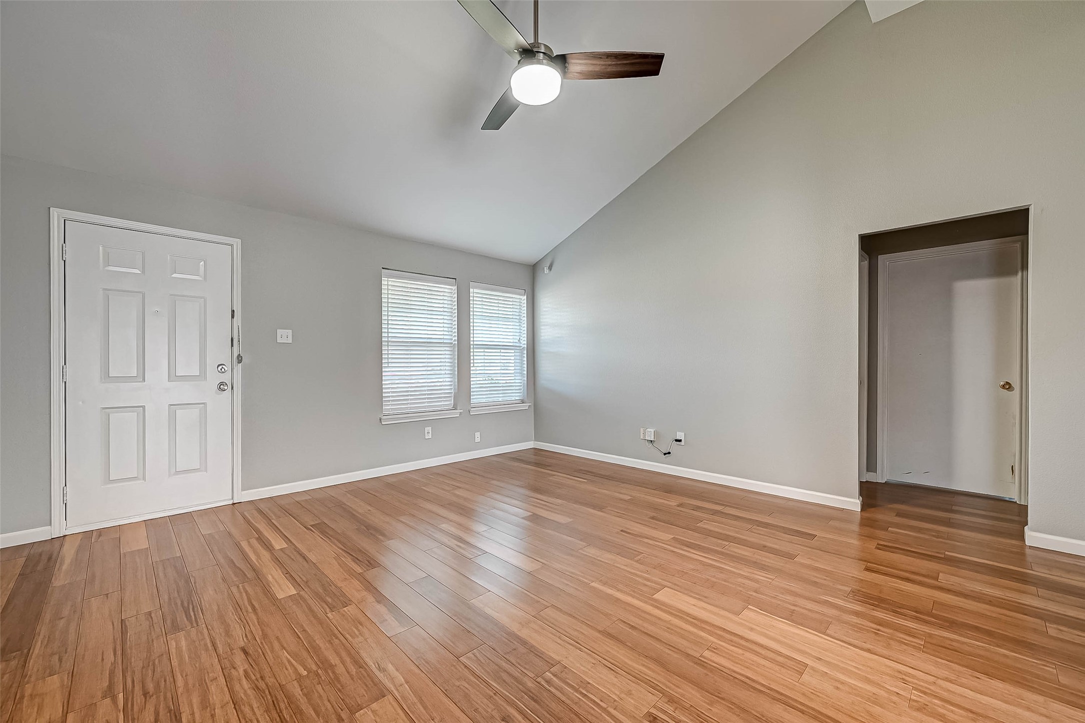 9466 Coast Bridge Street Houston, TX 77075 - Photo 3 of 29 a view of an empty room with wooden floor and a window