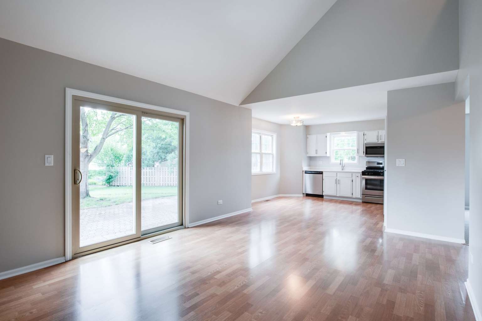 2203 Riverside Drive Plainfield, IL 60586 - Photo 4 of 25 a view of empty room with wooden floor and kitchen view