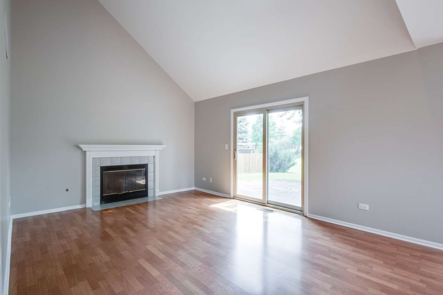 2203 Riverside Drive Plainfield, IL 60586 - Photo 6 of 25 an empty room with wooden floor fireplace and windows