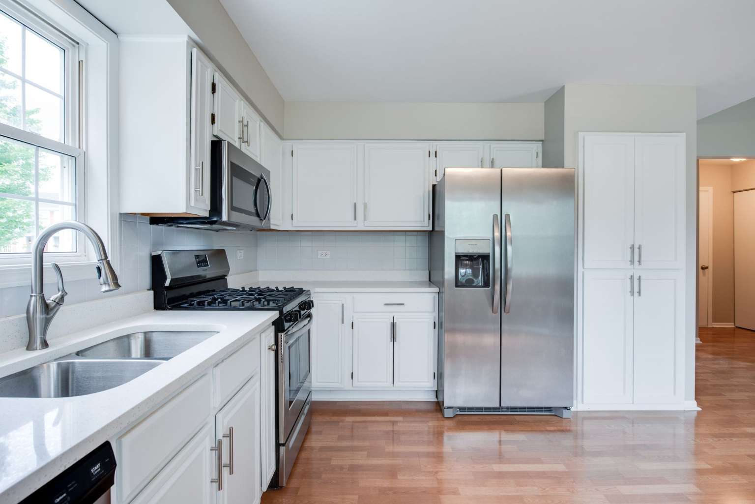 2203 Riverside Drive Plainfield, IL 60586 - Photo 9 of 25 a kitchen with a refrigerator sink and cabinets