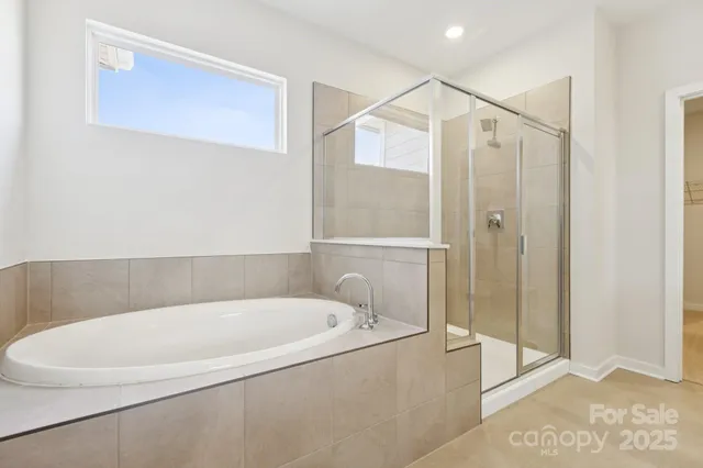 a white bath tub sitting next to a shower