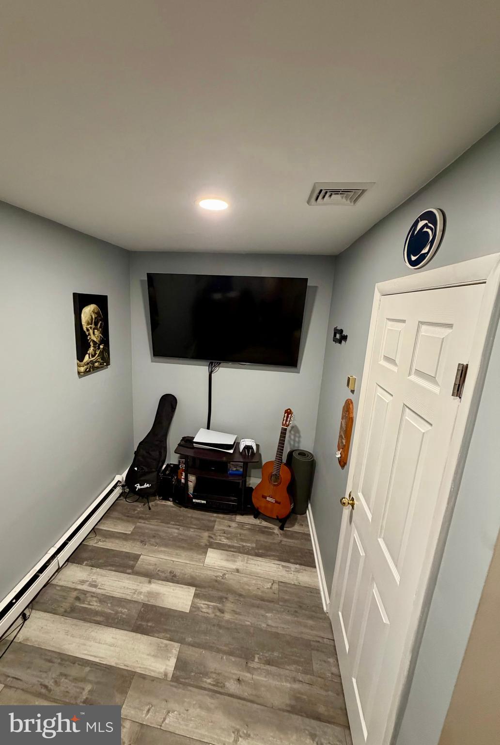 100 North 22nd Street, Unit 106 Philadelphia, PA 19103 - Photo 24 of 26 a bedroom with furniture and a wooden floor