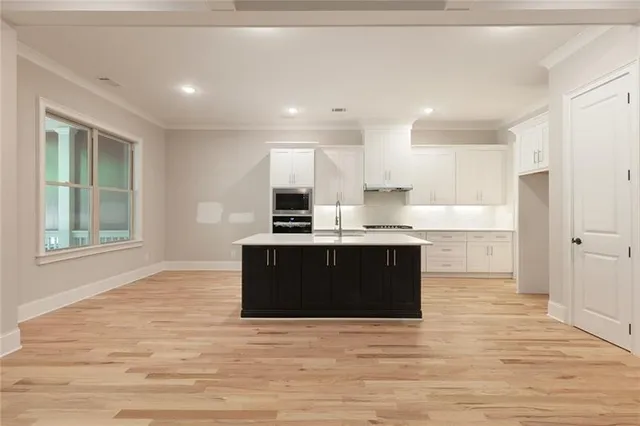 a kitchen with a sink stove and cabinets