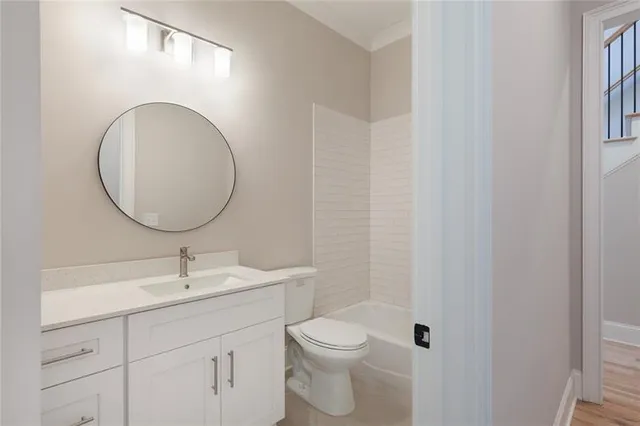 a bathroom with a toilet a sink and mirror