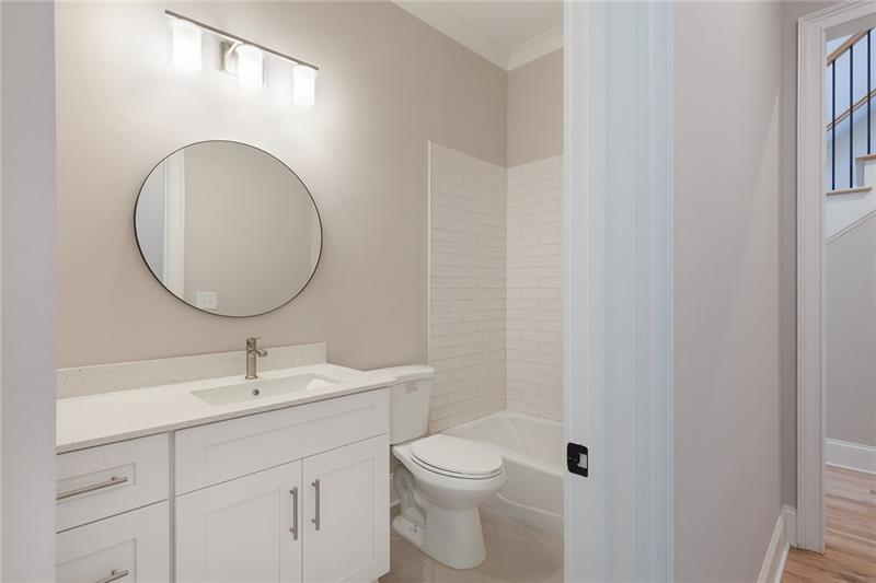 304 Trecastle Lane Canton, GA 30114 - Photo 15 of 31 a bathroom with a toilet a sink and mirror