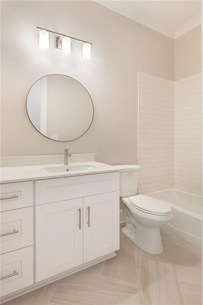 304 Trecastle Lane Canton, GA 30114 - Photo 16 of 31 a bathroom with a toilet a sink and mirror