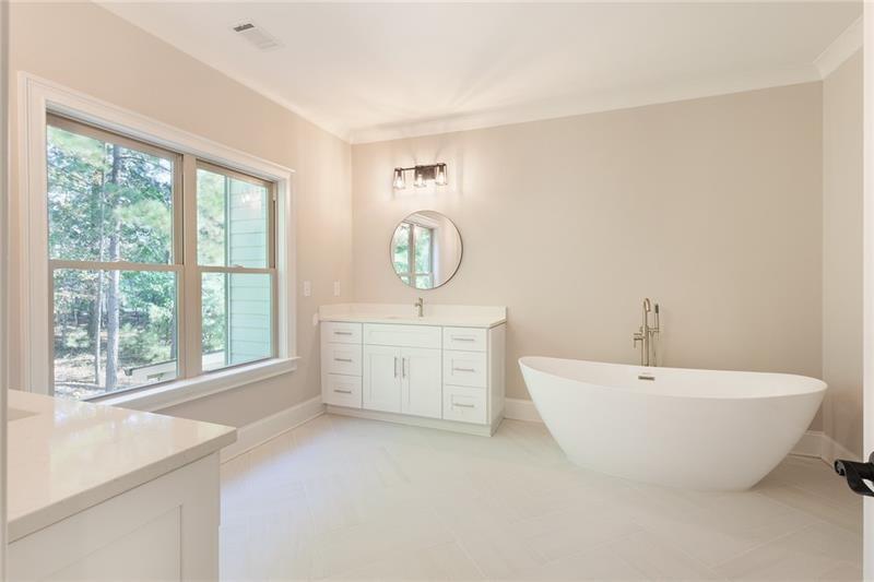 304 Trecastle Lane Canton, GA 30114 - Photo 20 of 31 a spacious bathroom with a bathtub and a sink