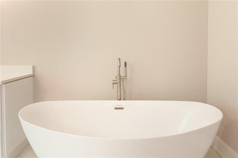 304 Trecastle Lane Canton, GA 30114 - Photo 22 of 31 a white tub sitting in a bathroom