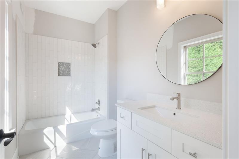 304 Trecastle Lane Canton, GA 30114 - Photo 29 of 31 a bathroom with a sink a toilet and a mirror