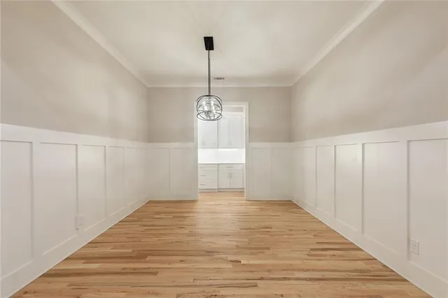 a large kitchen with kitchen island a sink stainless steel appliances and a large window