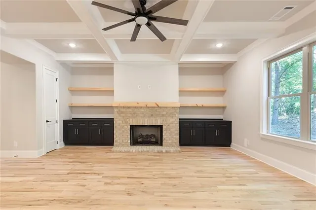 a large kitchen with stainless steel appliances granite countertop a stove a sink dishwasher and a refrigerator with wooden floor