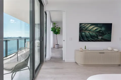 a spacious bedroom with a large bed and a flat screen tv