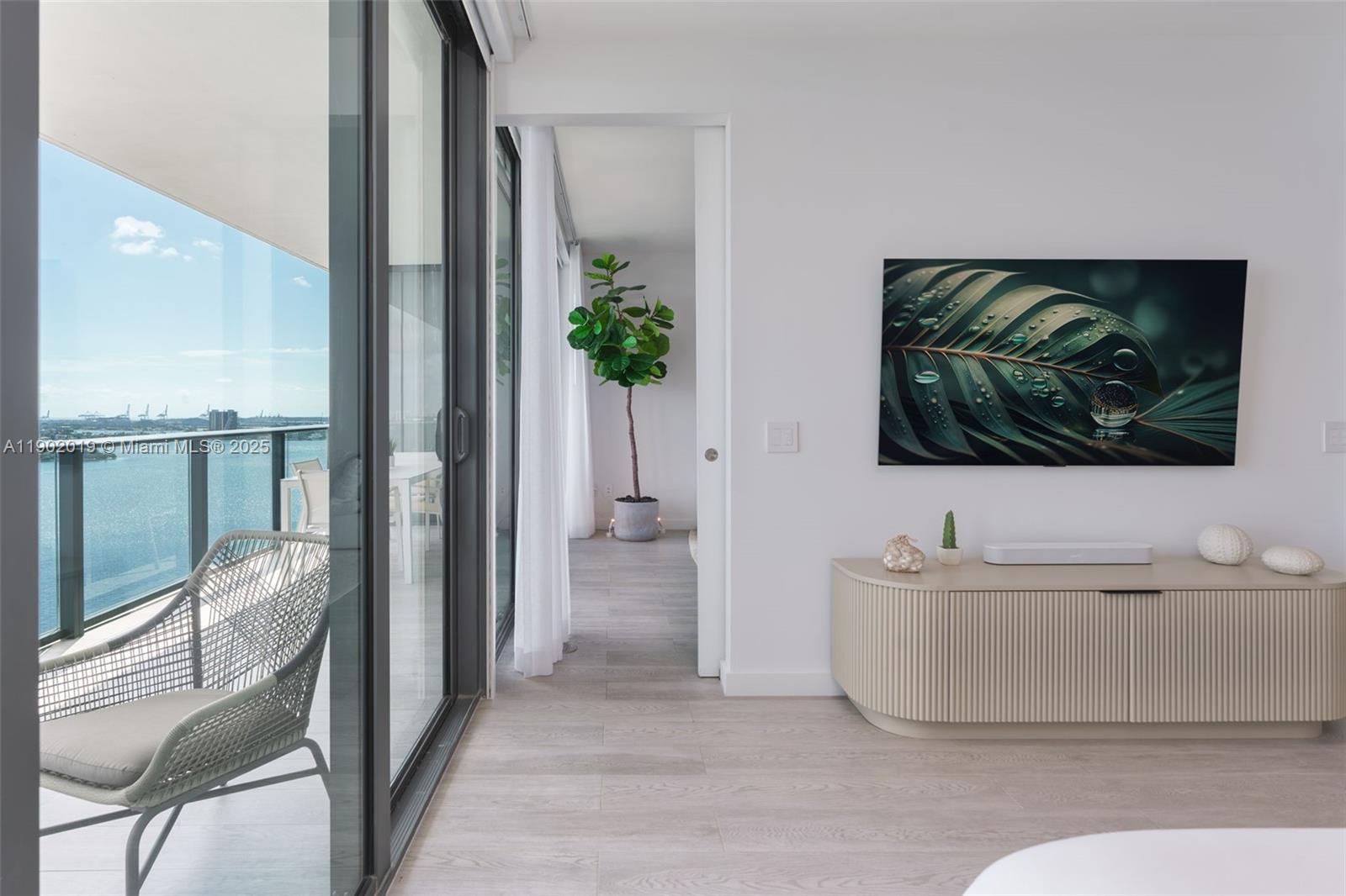 3131 Northeast 7th Avenue, Unit 2202 Miami, FL 33137 - Photo 12 of 68 a living room with a couch and a flat screen tv