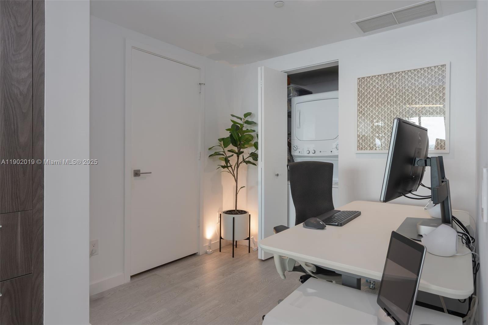 3131 Northeast 7th Avenue, Unit 2202 Miami, FL 33137 - Photo 19 of 68 a room with furniture and a potted plant