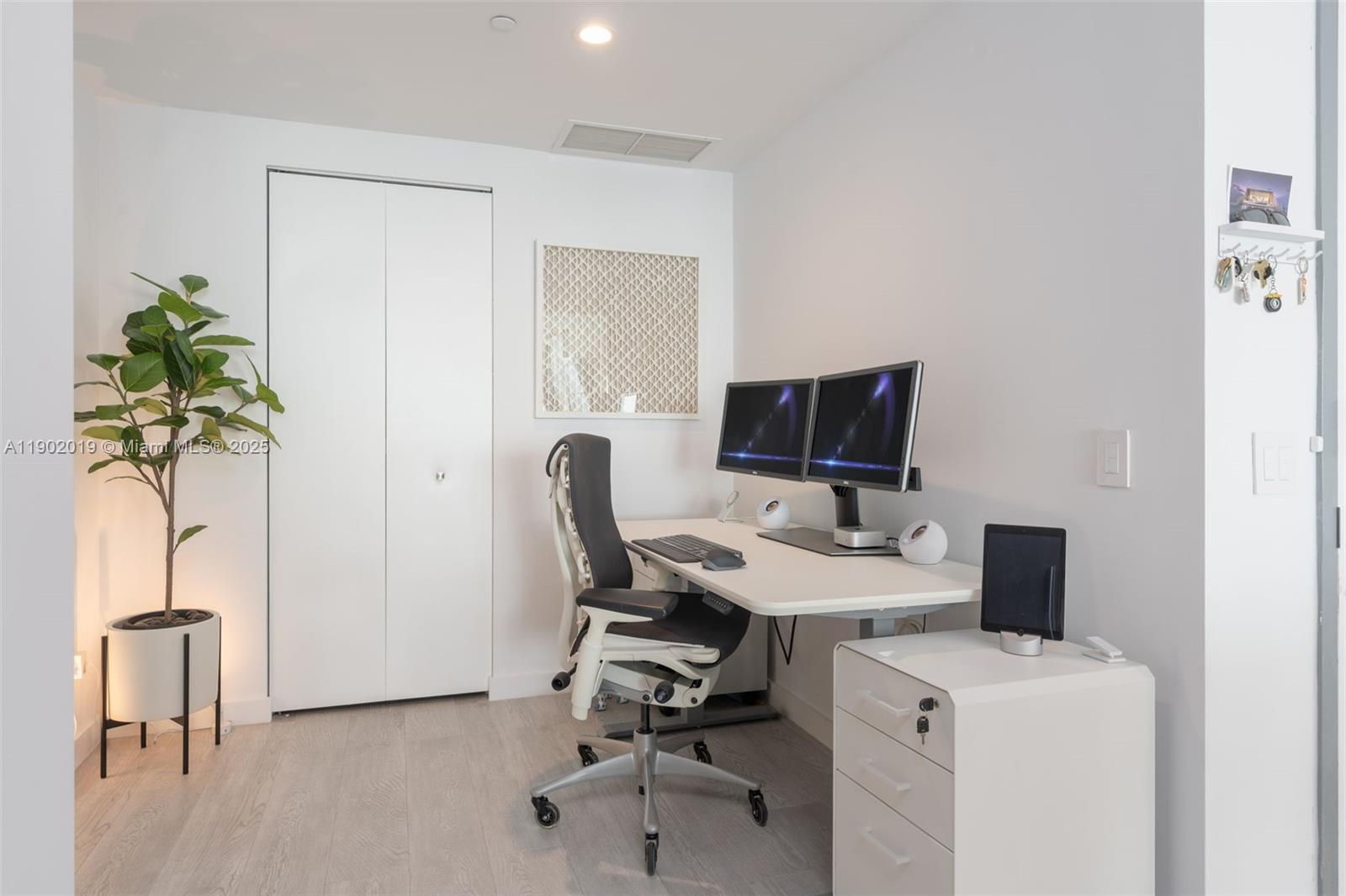 3131 Northeast 7th Avenue, Unit 2202 Miami, FL 33137 - Photo 20 of 68 a view of a workspace with furniture and a potted plant
