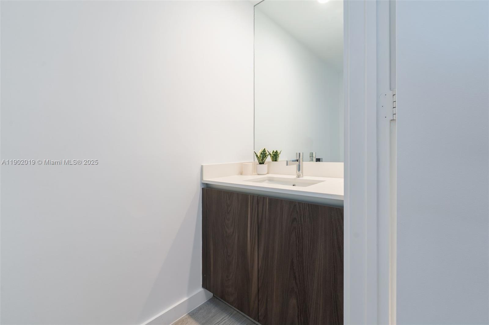 3131 Northeast 7th Avenue, Unit 2202 Miami, FL 33137 - Photo 21 of 68 a bathroom with a sink and a mirror