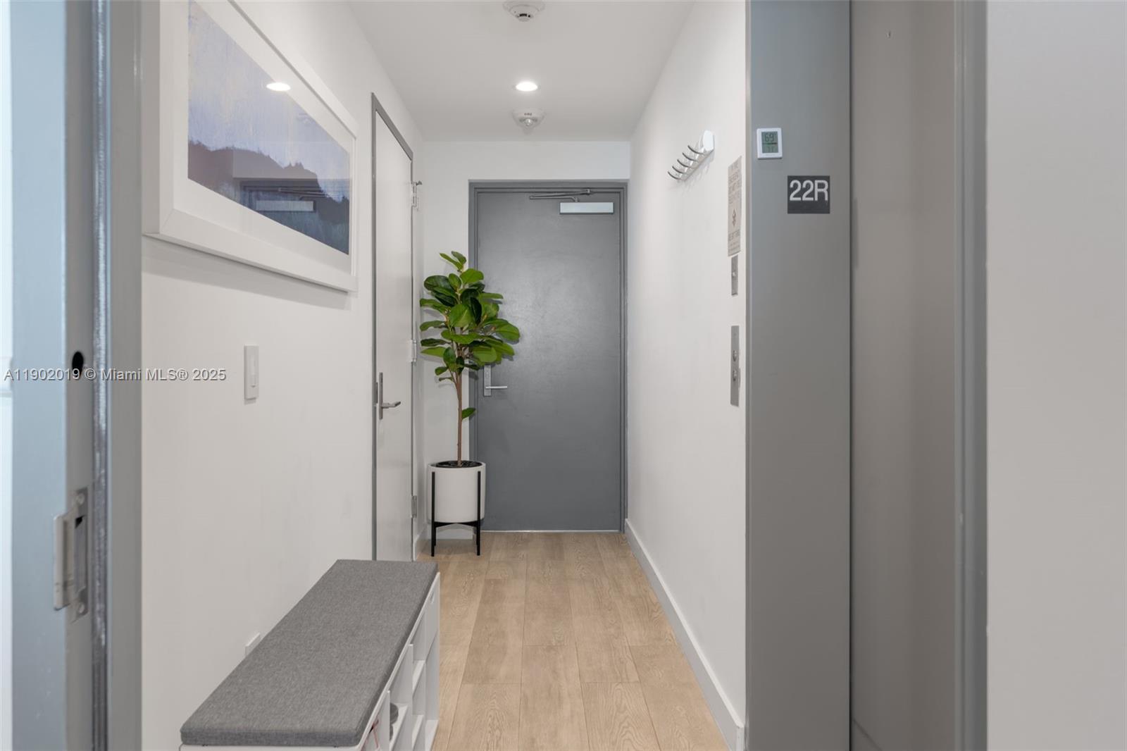 3131 Northeast 7th Avenue, Unit 2202 Miami, FL 33137 - Photo 22 of 68 a view of a hallway with wooden floor and a bathroom