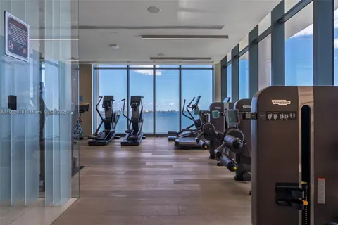 a living room with furniture potted plant and a large window