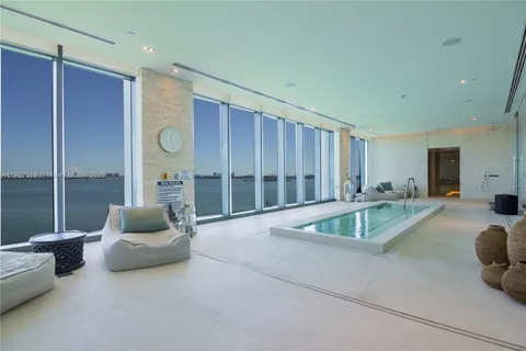 a view of a livingroom with furniture and a large window