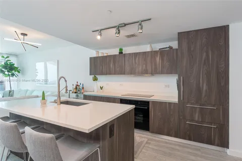 a kitchen with kitchen island a sink table and chairs
