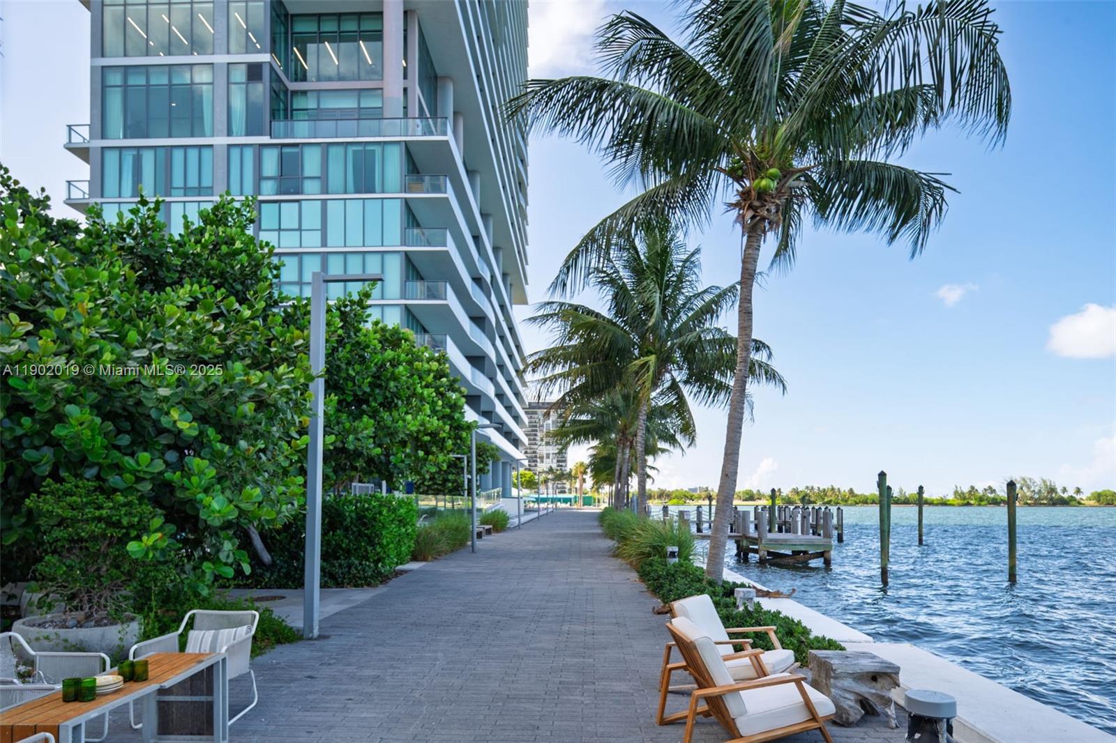 3131 Northeast 7th Avenue, Unit 2202 Miami, FL 33137 - Photo 53 of 68 a view of a palm tree with dinning table and chair in the patio