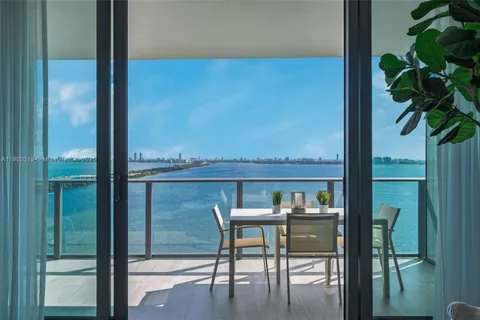 a view of a balcony with a table and chairs
