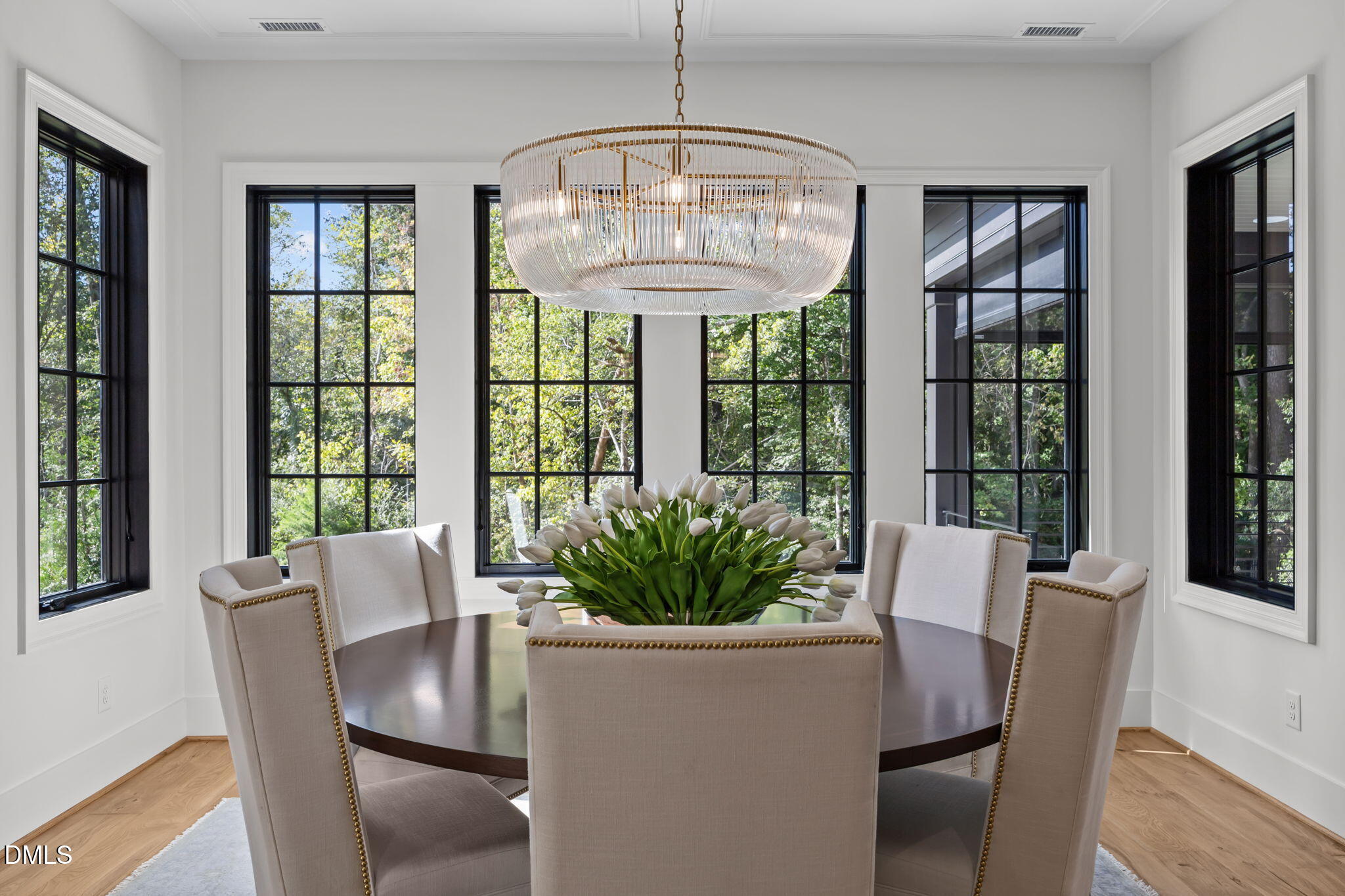 2733 Rothgeb Drive Raleigh, NC 27609 - Photo 21 of 63 a view of a dining room with furniture large windows and wooden floor