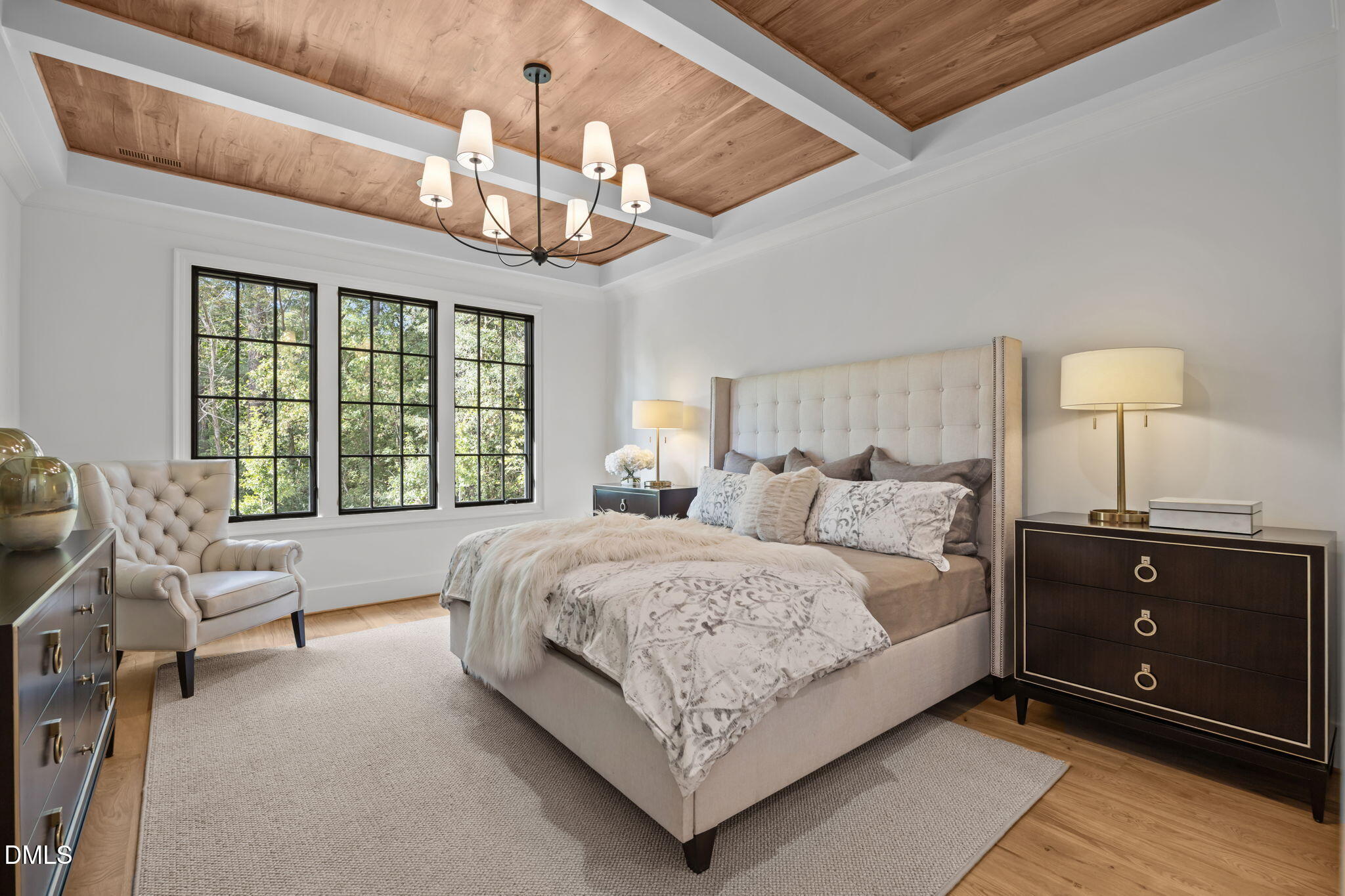 2733 Rothgeb Drive Raleigh, NC 27609 - Photo 29 of 63 a spacious bedroom with a bed and a chandelier