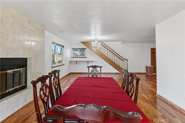a dining room with furniture and wooden floor