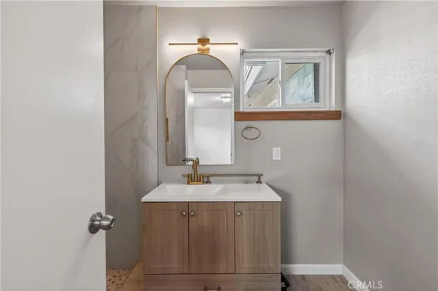 a bathroom with a sink and a mirror