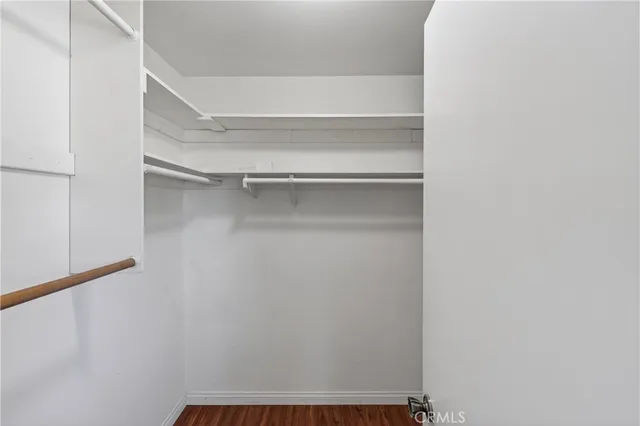 a view of walk in closet with empty racks