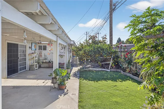 a view of a house with backyard and sitting area