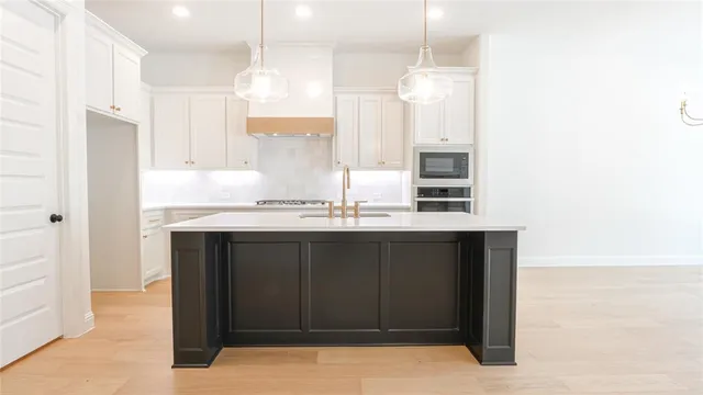 a kitchen with granite countertop a sink cabinets and window
