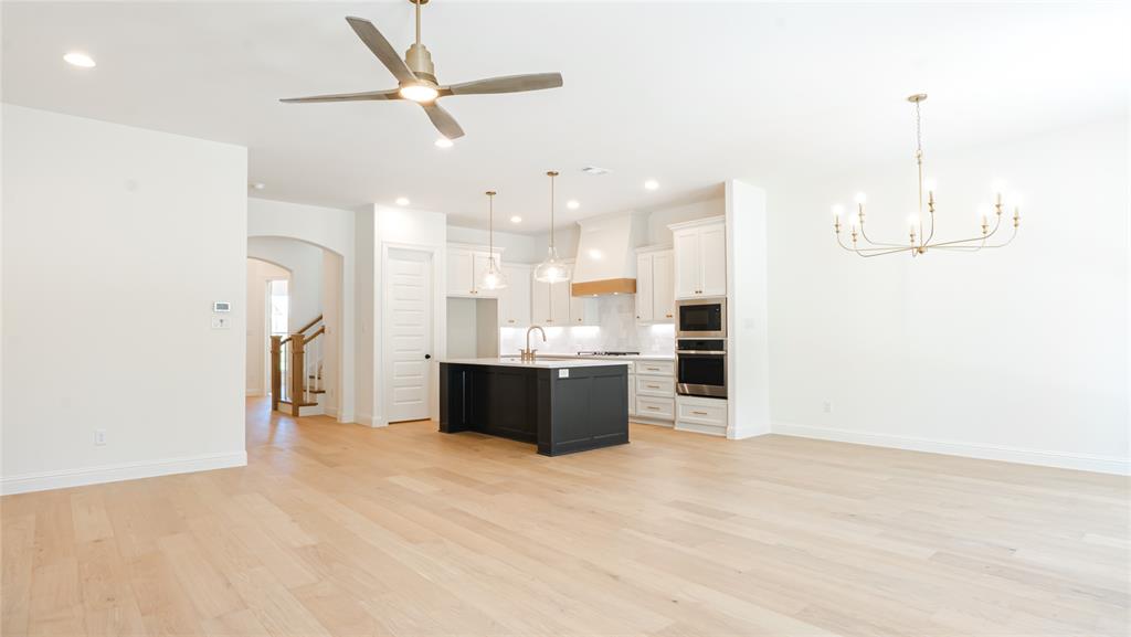 427 Wingtail Drive Aledo, TX 76008 - Photo 12 of 13 a large room with kitchen view and a chandelier fan