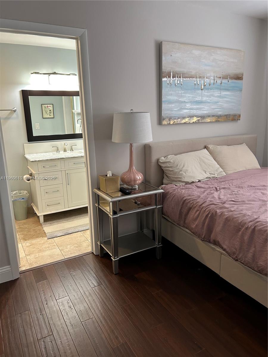 5555 Ludlam Road, Unit 501 South Miami, FL 33155 - Photo 11 of 20 a bedroom with a bed and a window