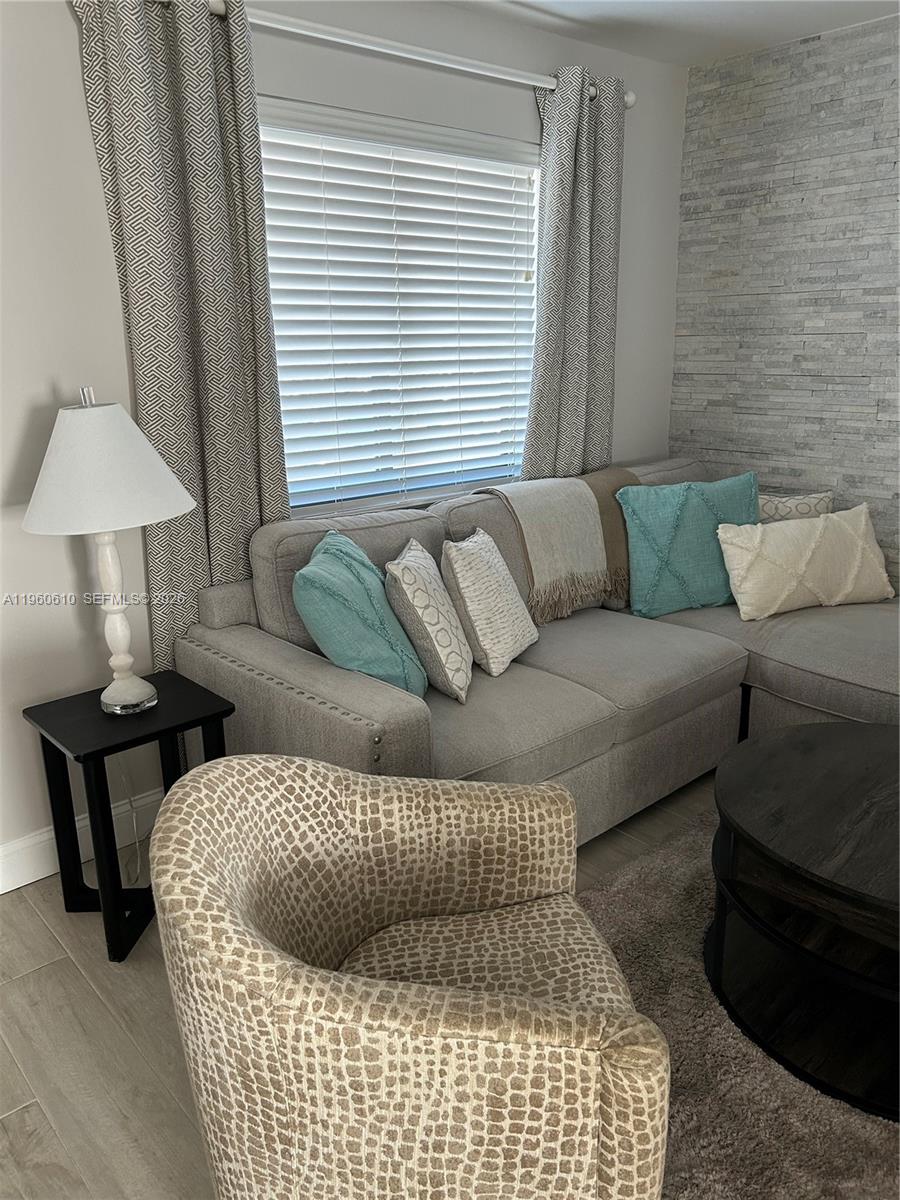 5555 Ludlam Road, Unit 501 South Miami, FL 33155 - Photo 7 of 20 a living room with furniture