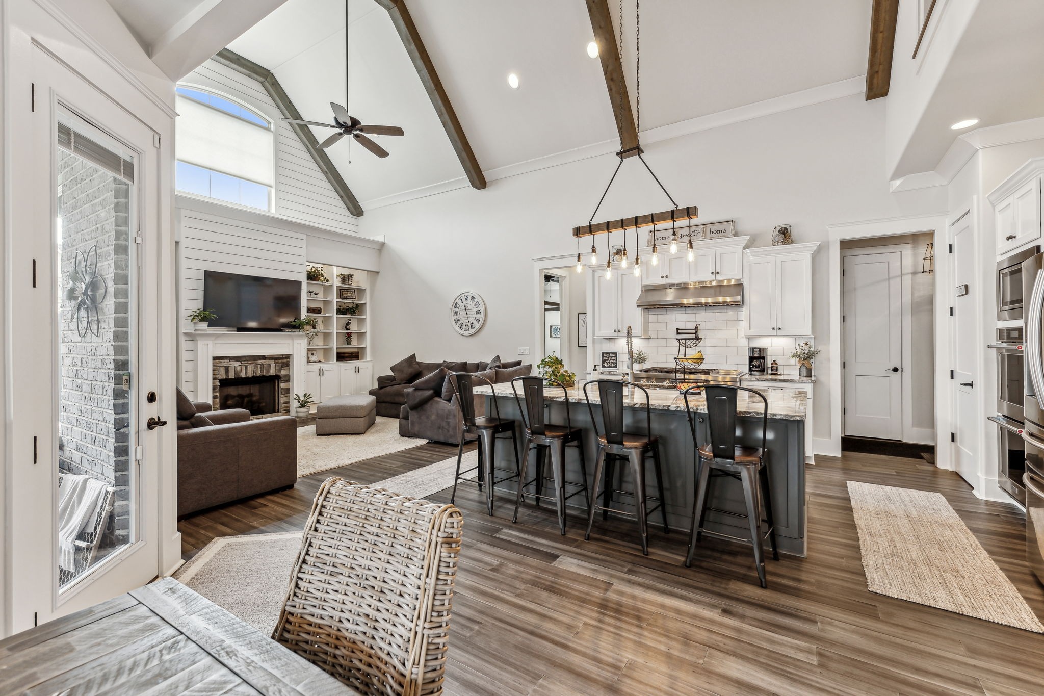 2054 Autumn Ridge Way Spring Hill, TN 37174 - Photo 14 of 50 a large kitchen with stainless steel appliances granite countertop a stove refrigerator a dining table and chairs with wooden floor