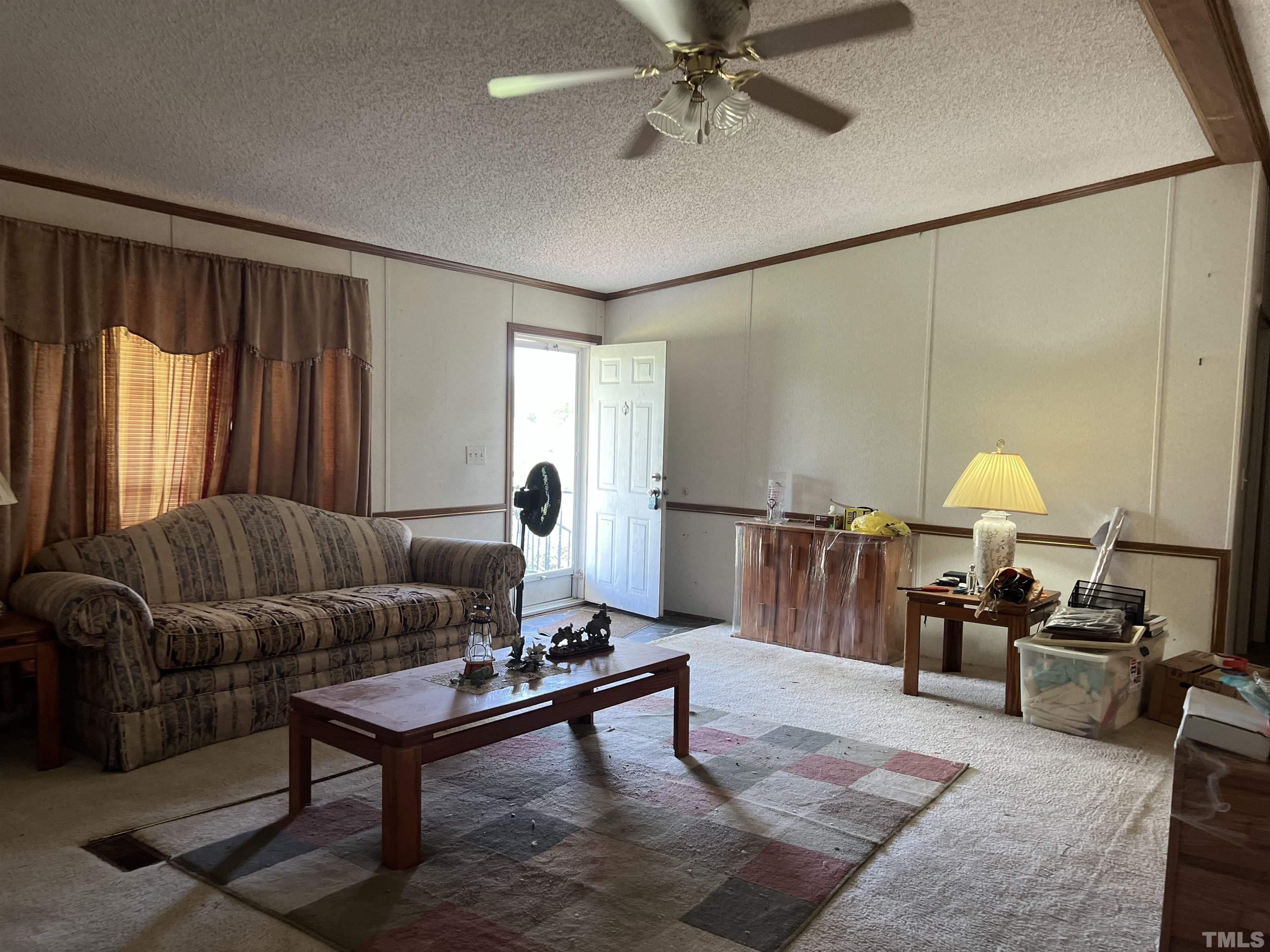 772 Nutgrass Road Bunnlevel, NC 28323 - Photo 4 of 6 a living room with furniture a window and a flat screen tv