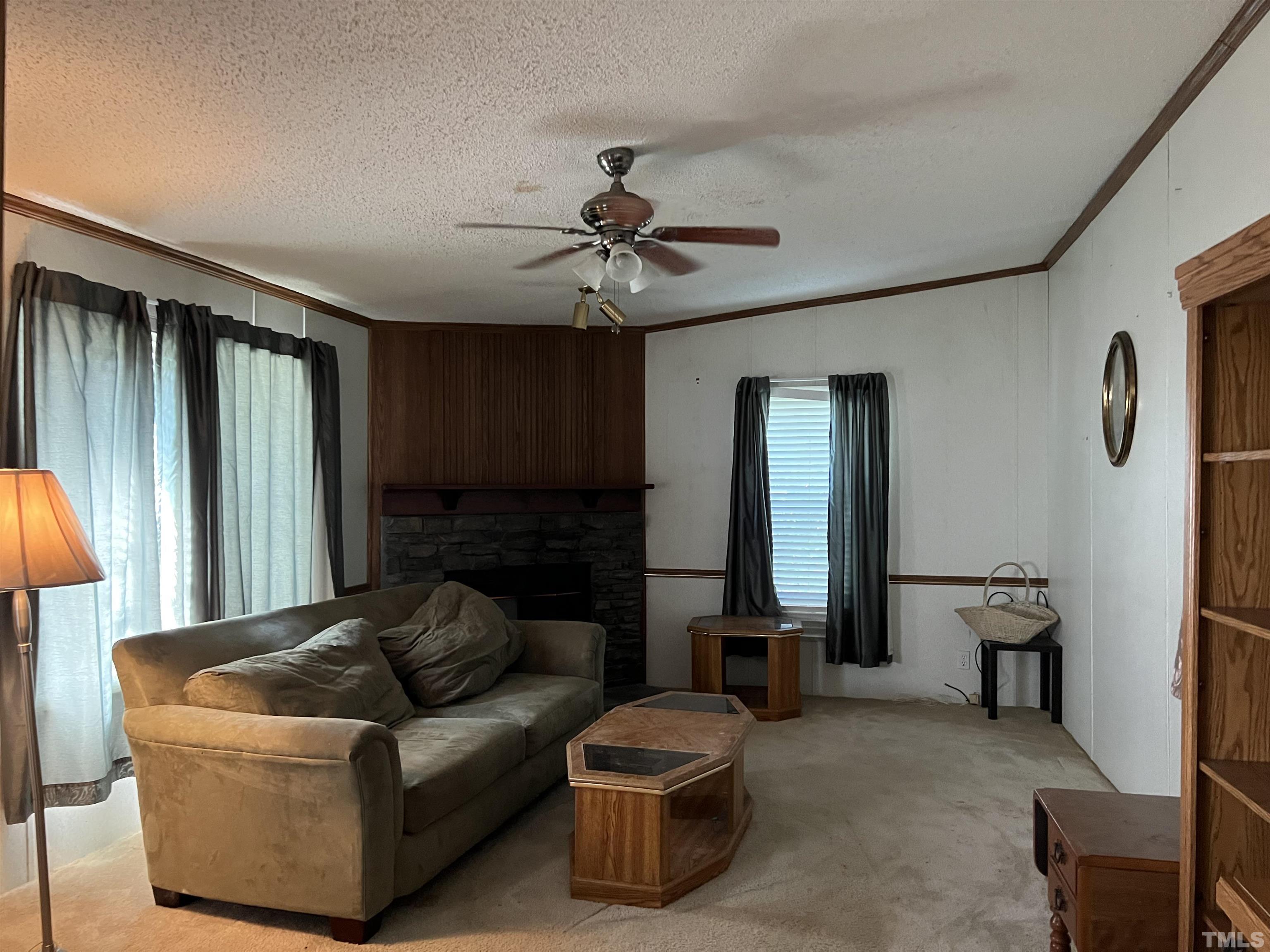 772 Nutgrass Road Bunnlevel, NC 28323 - Photo 6 of 6 a living room with furniture and a fireplace