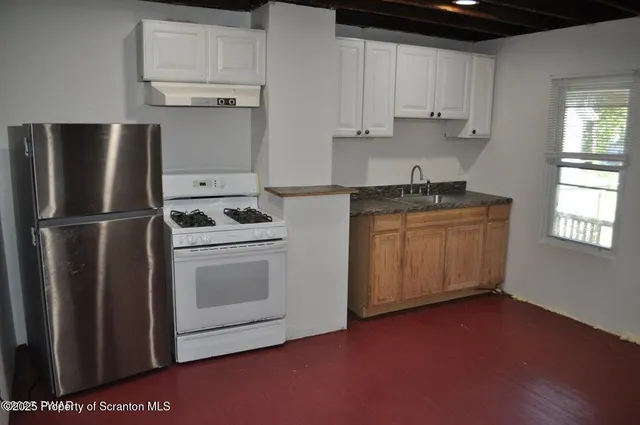 a kitchen with stainless steel appliances a stove a microwave and a refrigerator