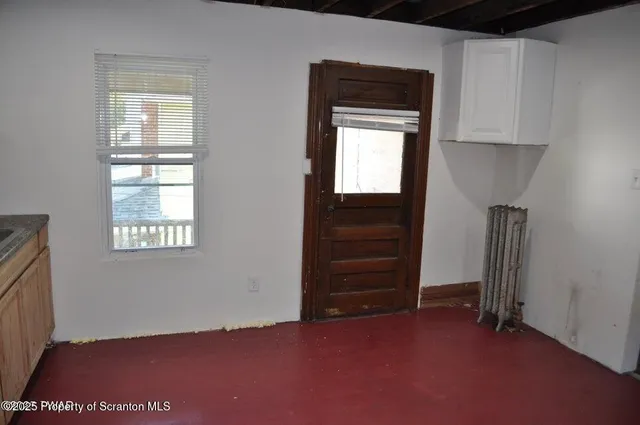 an empty room with windows and closet
