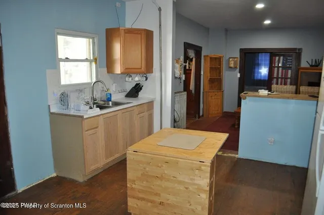 a kitchen with a sink a stove and refrigerator