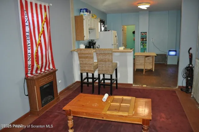 a dining room with furniture and wooden floor