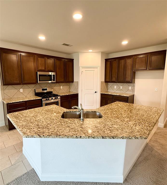 204 Flower Ridge Drive Fort Worth, TX 76108 - Photo 14 of 27 a kitchen with stainless steel appliances granite countertop a sink stove and refrigerator